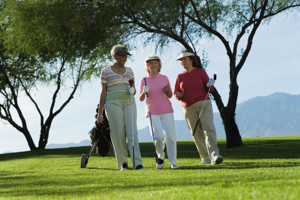 A group of female golfers walking a round of golf. 