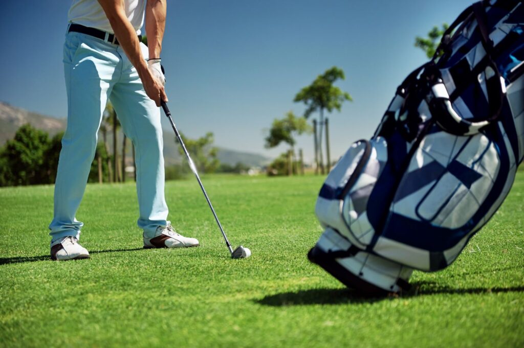 A golfer standing over a ball to hit a shot.