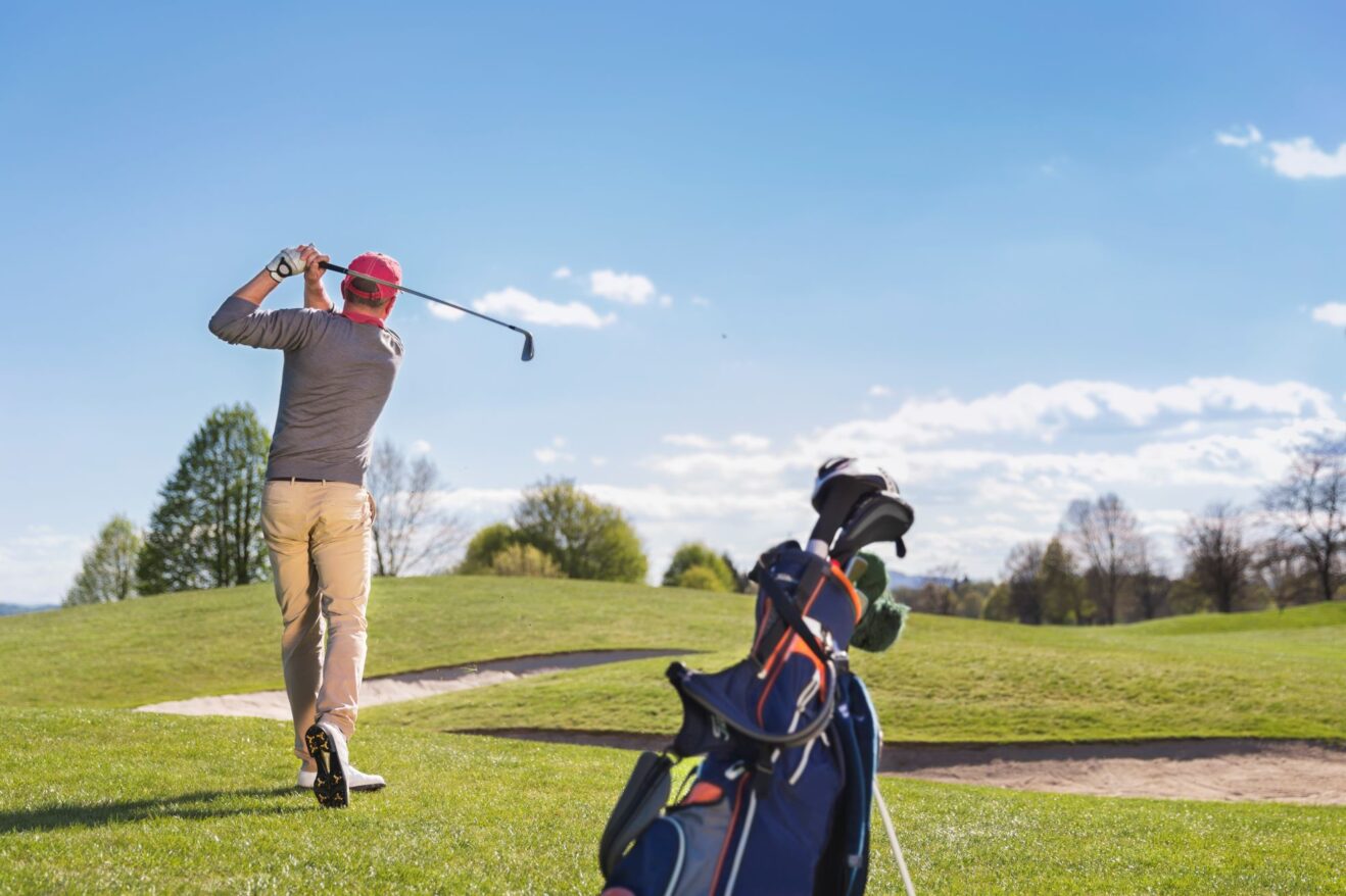 Golfer practicing golf by himself.