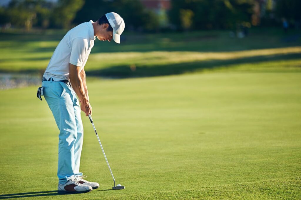 A golfer practicing a putting drill on a golf green. 